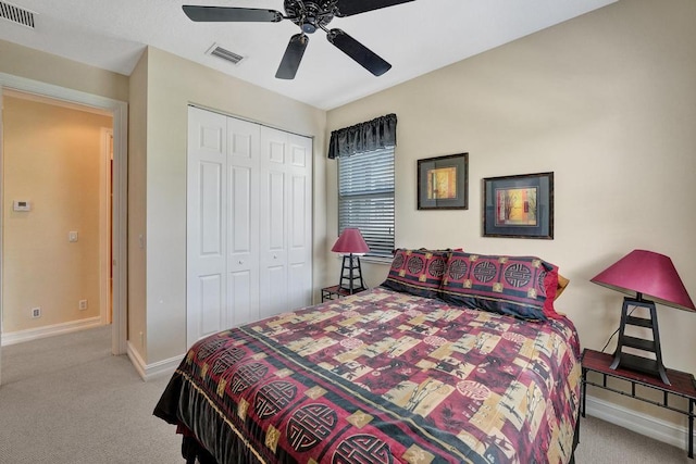 bedroom featuring light colored carpet, a closet, and ceiling fan