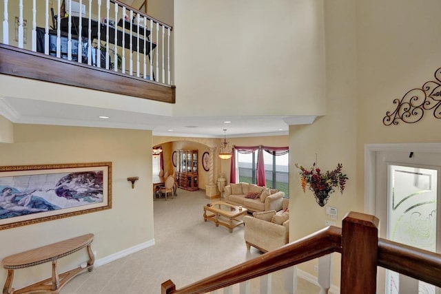 interior space featuring crown molding, a towering ceiling, and tile patterned floors