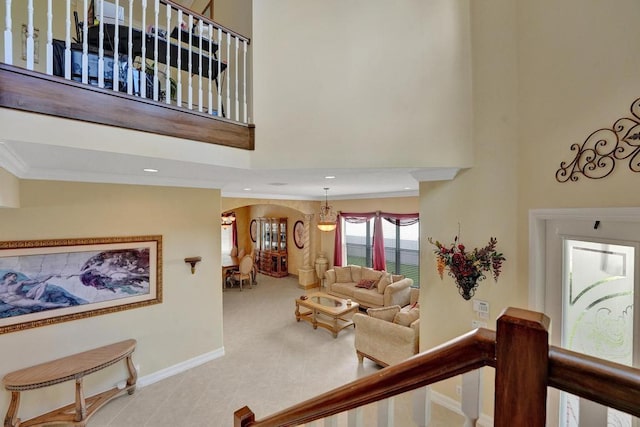 interior space featuring crown molding and a towering ceiling