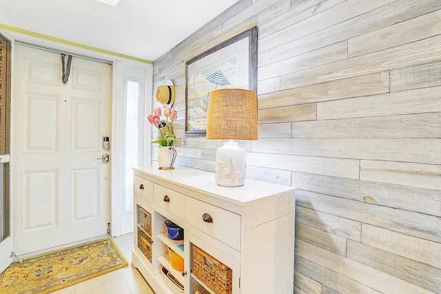 entryway with wooden walls