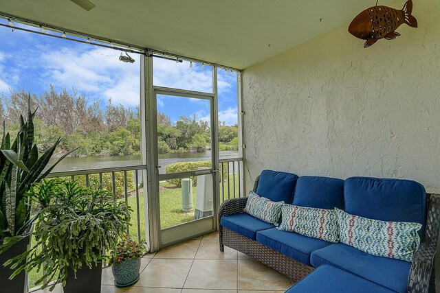 sunroom / solarium featuring a water view