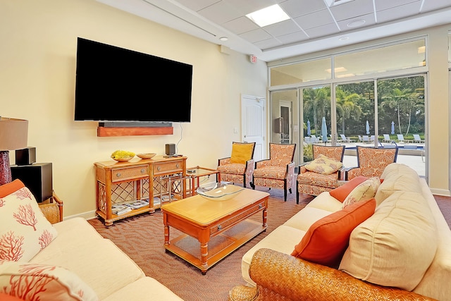 living room with a drop ceiling