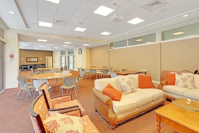 carpeted living room with a paneled ceiling