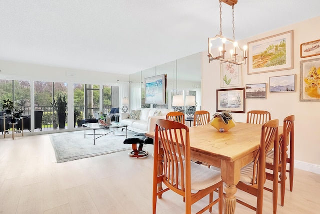 dining space featuring a chandelier and light hardwood / wood-style flooring