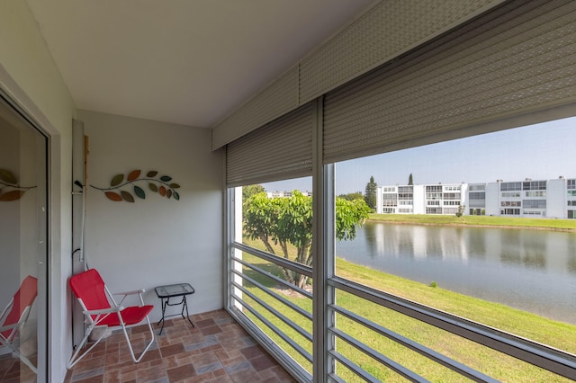 sunroom / solarium with a water view