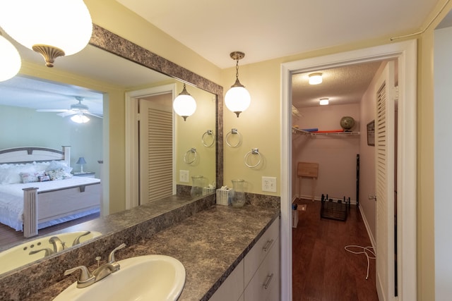 bathroom with ceiling fan, wood-type flooring, and vanity