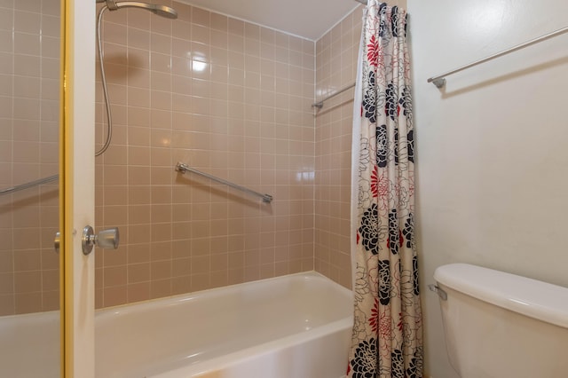 bathroom featuring shower / bathtub combination with curtain and toilet