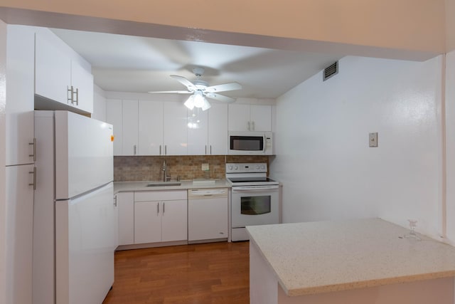 kitchen featuring white appliances, ceiling fan, sink, tasteful backsplash, and light hardwood / wood-style floors