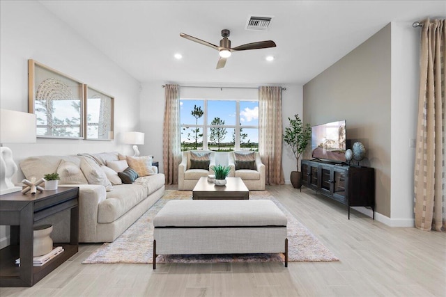 living room with ceiling fan and light wood-type flooring