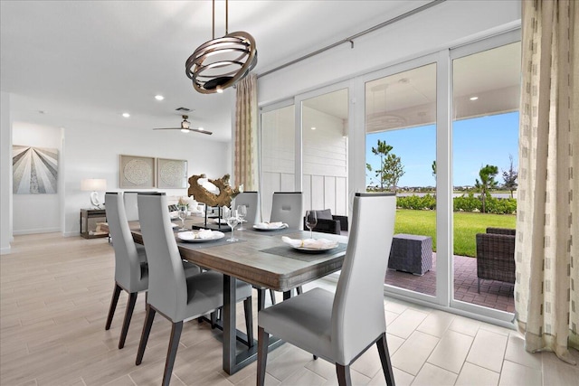 dining room with ceiling fan and light hardwood / wood-style floors