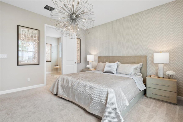 carpeted bedroom with a chandelier and ensuite bath