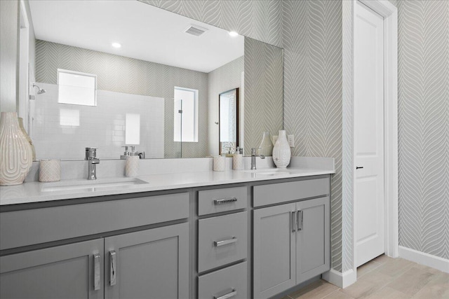 bathroom featuring a shower and vanity