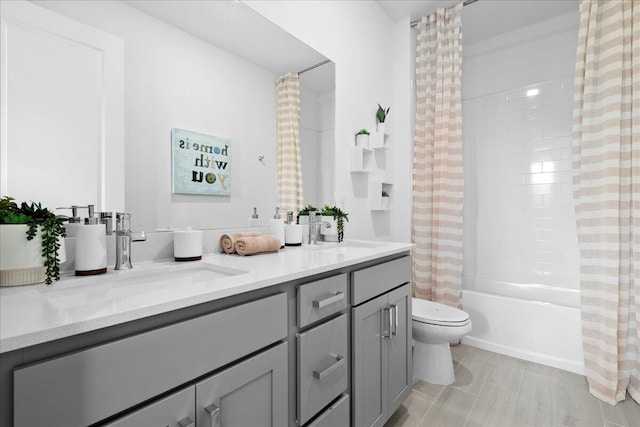 full bathroom featuring shower / tub combo, vanity, and toilet