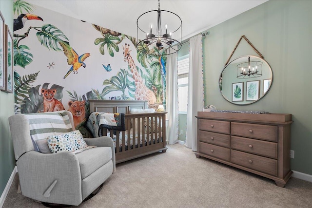 bedroom featuring light carpet, a nursery area, and an inviting chandelier