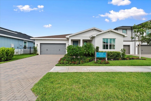 view of front of property featuring a front yard and a garage