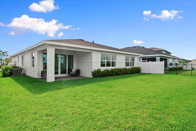 back of property featuring a lawn, a patio area, and central AC unit