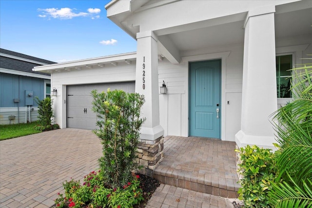 view of exterior entry featuring a garage