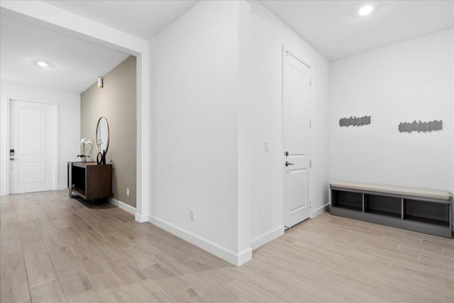 corridor with light wood-type flooring