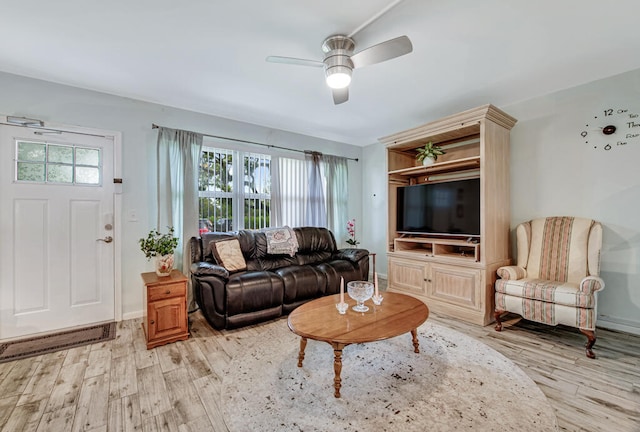 living room featuring light wood-type flooring and ceiling fan