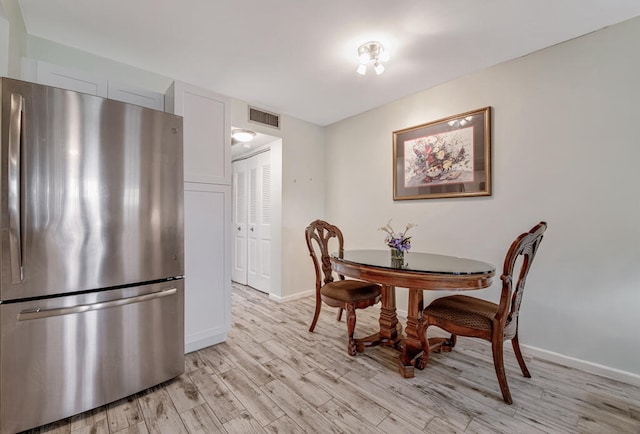 dining area with light wood-type flooring