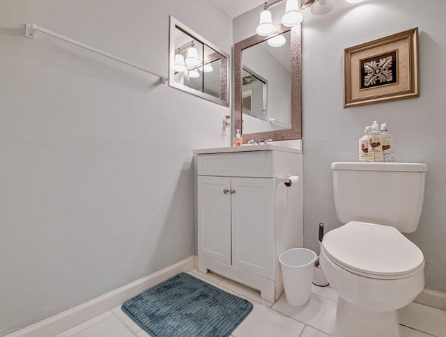 bathroom with vanity, toilet, and tile patterned floors