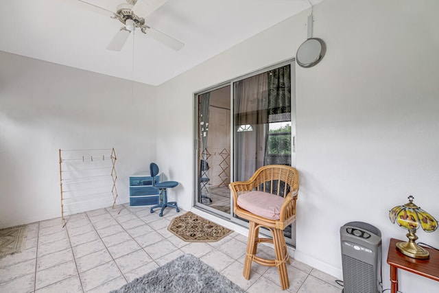 interior space with ceiling fan and a patio