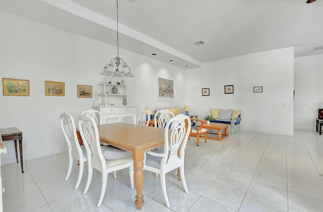 dining space with a notable chandelier and light tile patterned flooring