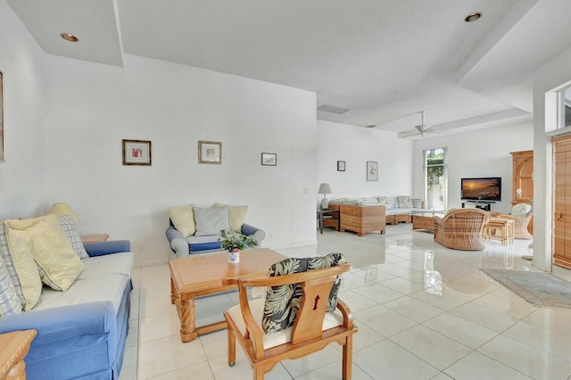 living room with ceiling fan and light tile patterned floors