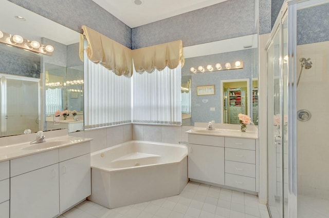 bathroom featuring tile patterned floors, vanity, and shower with separate bathtub