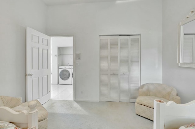 sitting room with light carpet and washer and dryer