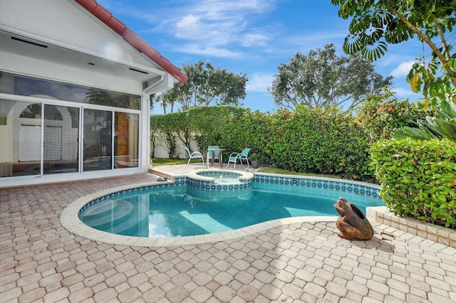 view of pool with an in ground hot tub and a patio area