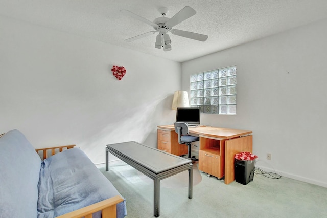 office with ceiling fan, a textured ceiling, and light carpet