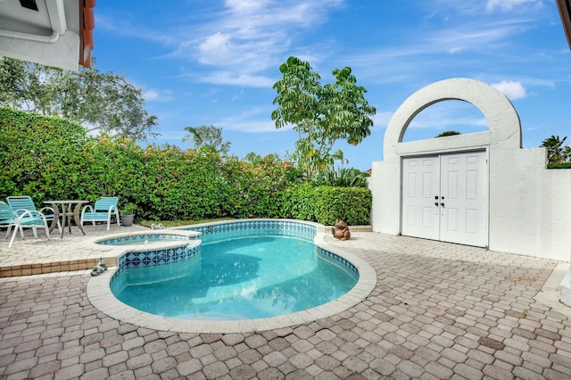 view of pool with an in ground hot tub and a patio area