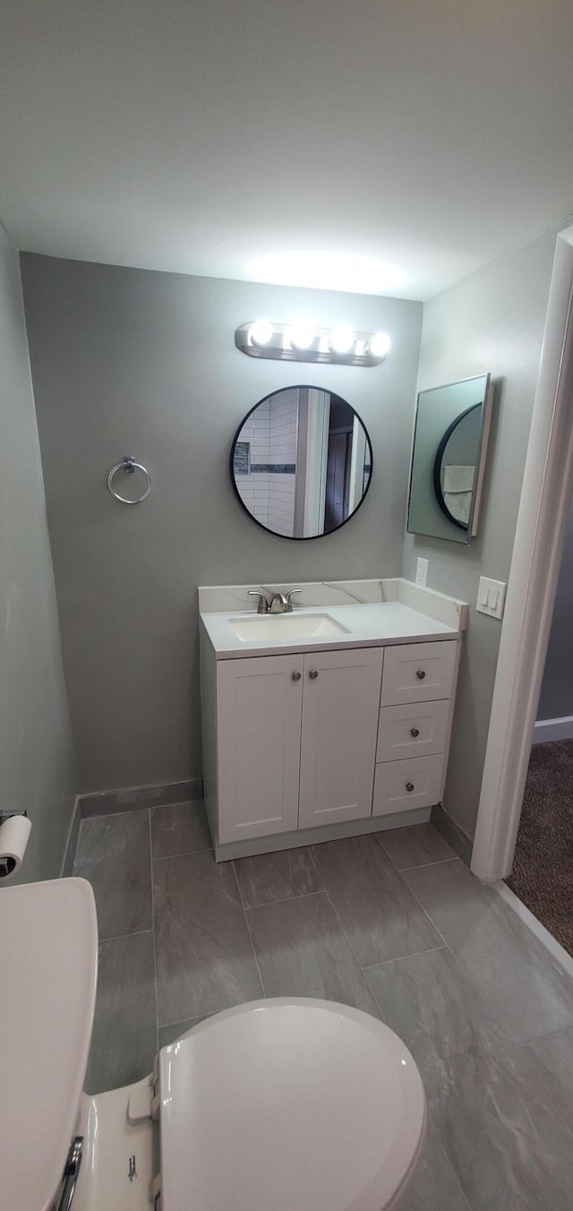 bathroom featuring vanity, a bathtub, and tile patterned flooring