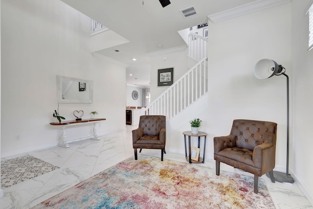 sitting room with light tile patterned floors, a towering ceiling, and crown molding