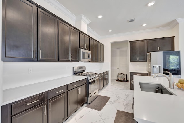 kitchen featuring appliances with stainless steel finishes, light tile patterned floors, sink, and dark brown cabinets