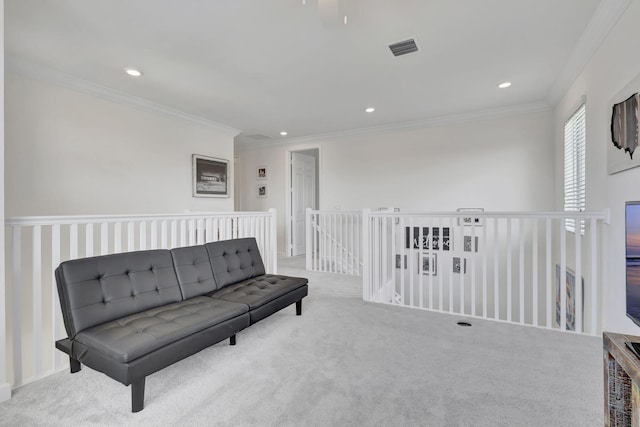 living area with crown molding and light carpet