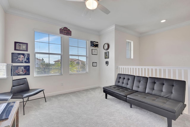 living room featuring carpet, ornamental molding, and ceiling fan