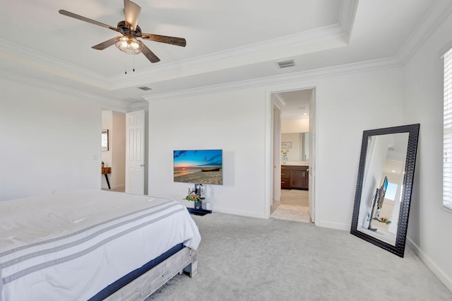 bedroom featuring ceiling fan, a tray ceiling, light colored carpet, and ornamental molding