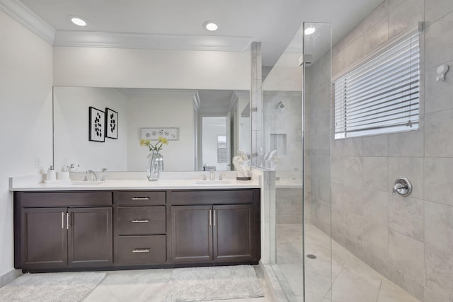 bathroom with double vanity, crown molding, a shower with door, and tile patterned floors