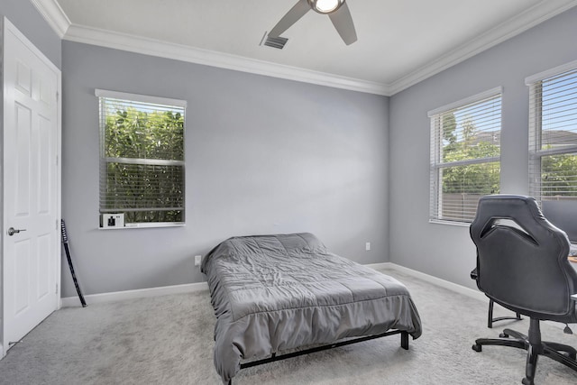 carpeted bedroom featuring ceiling fan, crown molding, and multiple windows