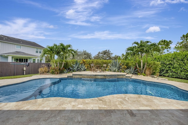 view of swimming pool with pool water feature and a patio