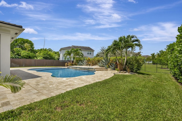 view of swimming pool featuring a patio and a yard