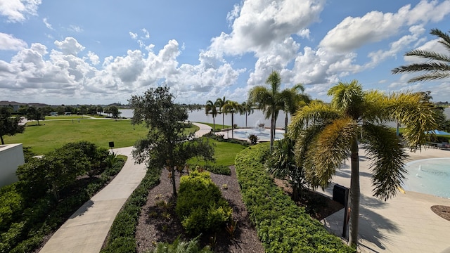 view of community featuring a yard and a water view