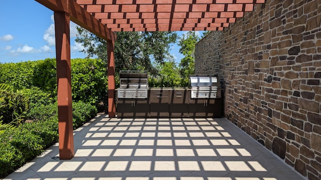 view of patio / terrace featuring a pergola, grilling area, and exterior kitchen