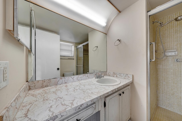 bathroom featuring walk in shower, toilet, and vanity