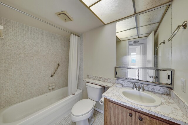 full bathroom with shower / bath combo, tile patterned floors, vanity, and toilet