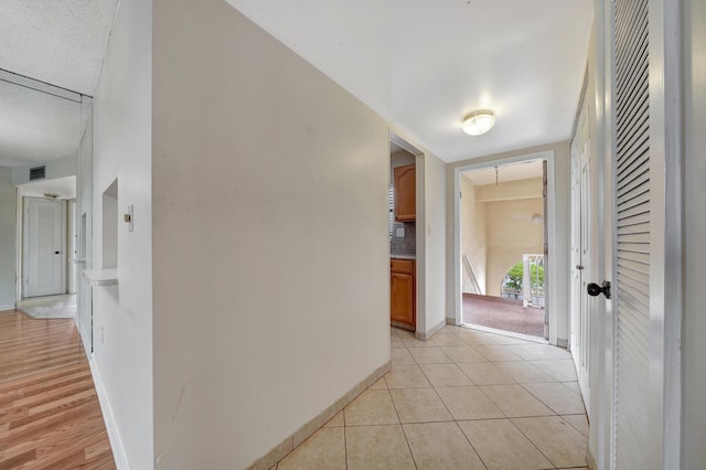 hallway with light tile patterned floors