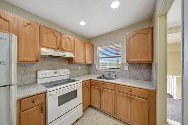 kitchen with sink, white appliances, light tile patterned floors, light brown cabinetry, and decorative backsplash