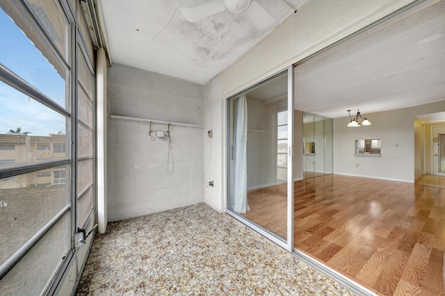 bathroom with hardwood / wood-style floors and an inviting chandelier